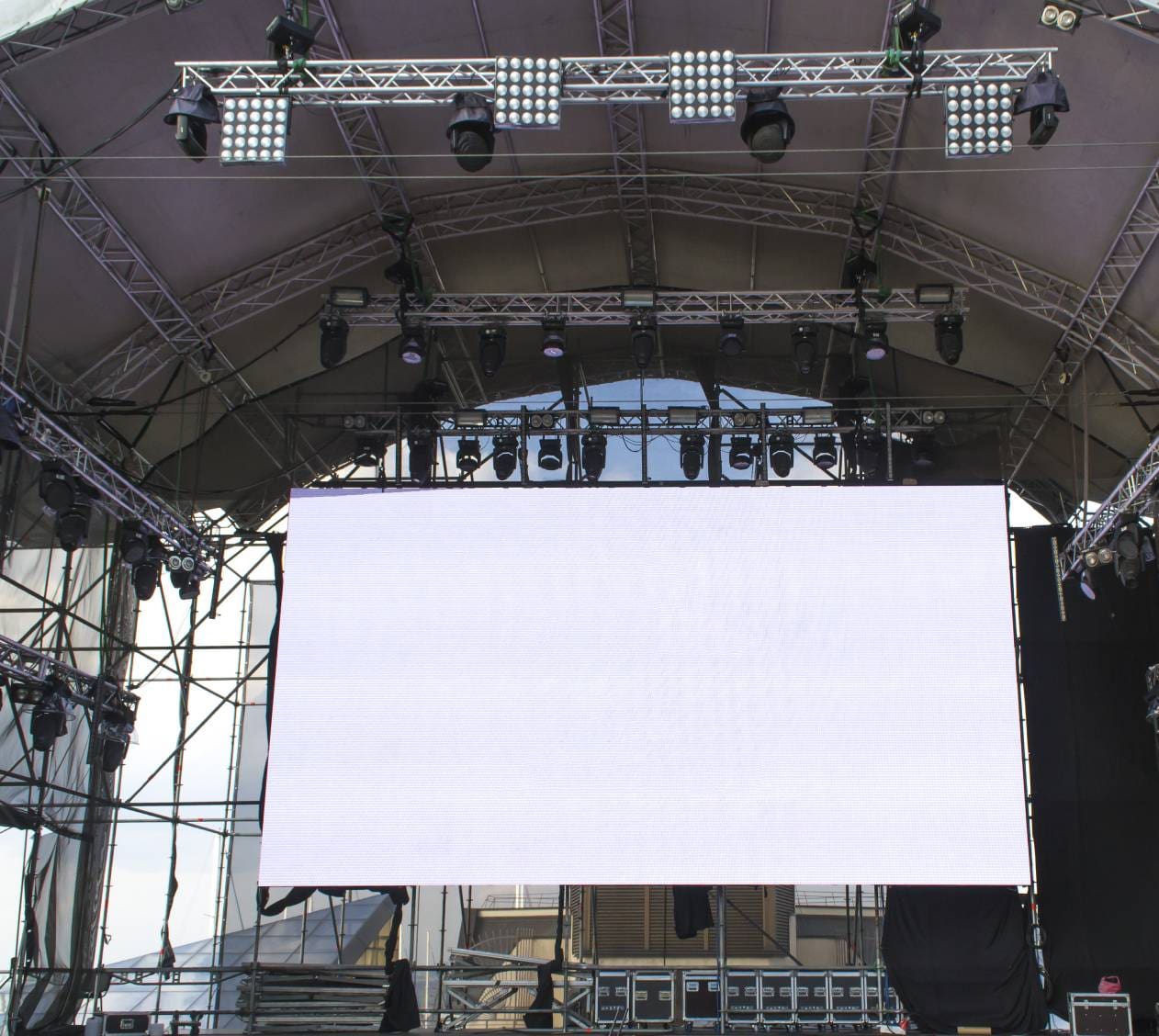 Large blank screen under stage lights.