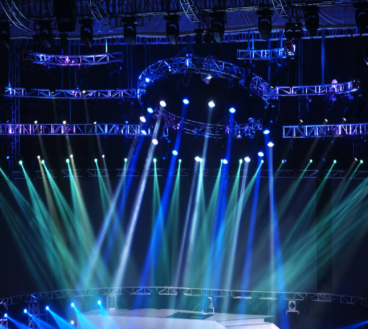 Concert stage with blue and green lights.