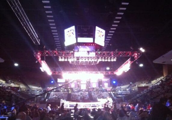 Boxing match in a large arena.